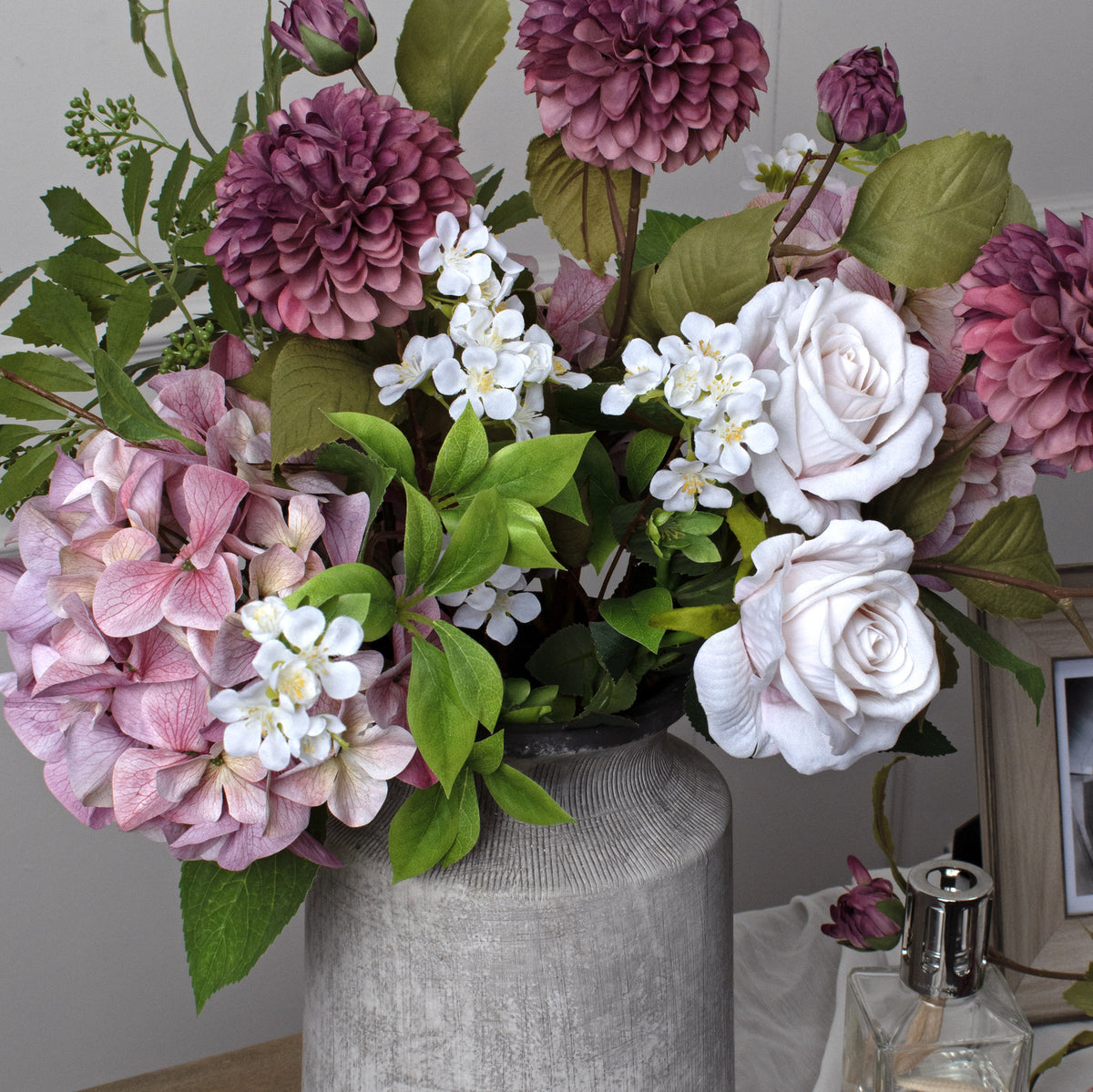 Close-up of the Bloomville Urn Vase neck beneath a mauve and white flower arrangement