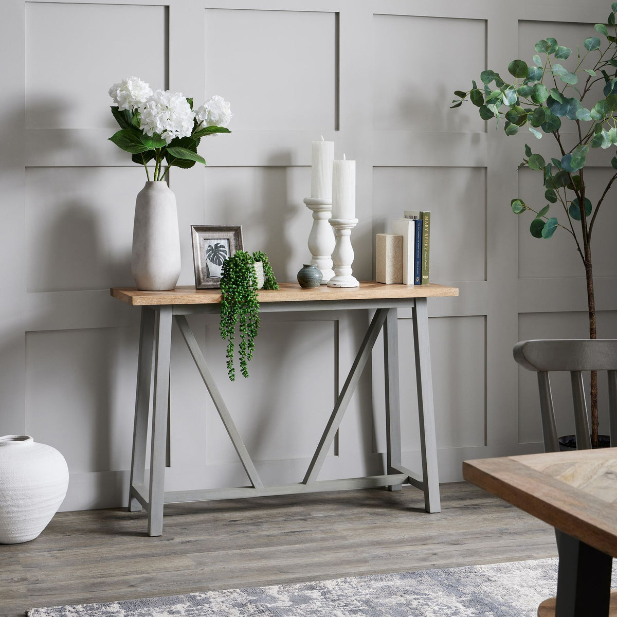 Darcy Ople Tall Vase with white flowers at the left of a styled console table