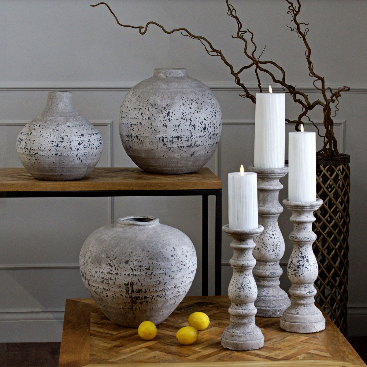 Stone-effect Regola and Tiber vases grouped with pillar candle holders and lemons