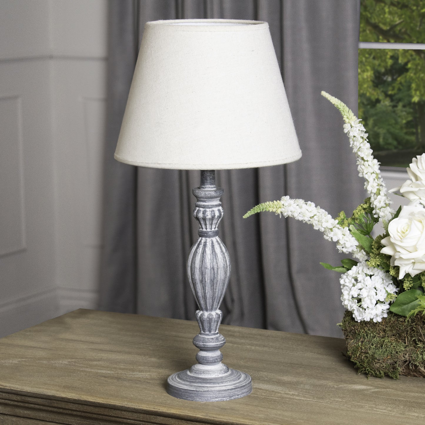Aegina Table Lamp: Meticulously carved from wood with a weathered neutral finish