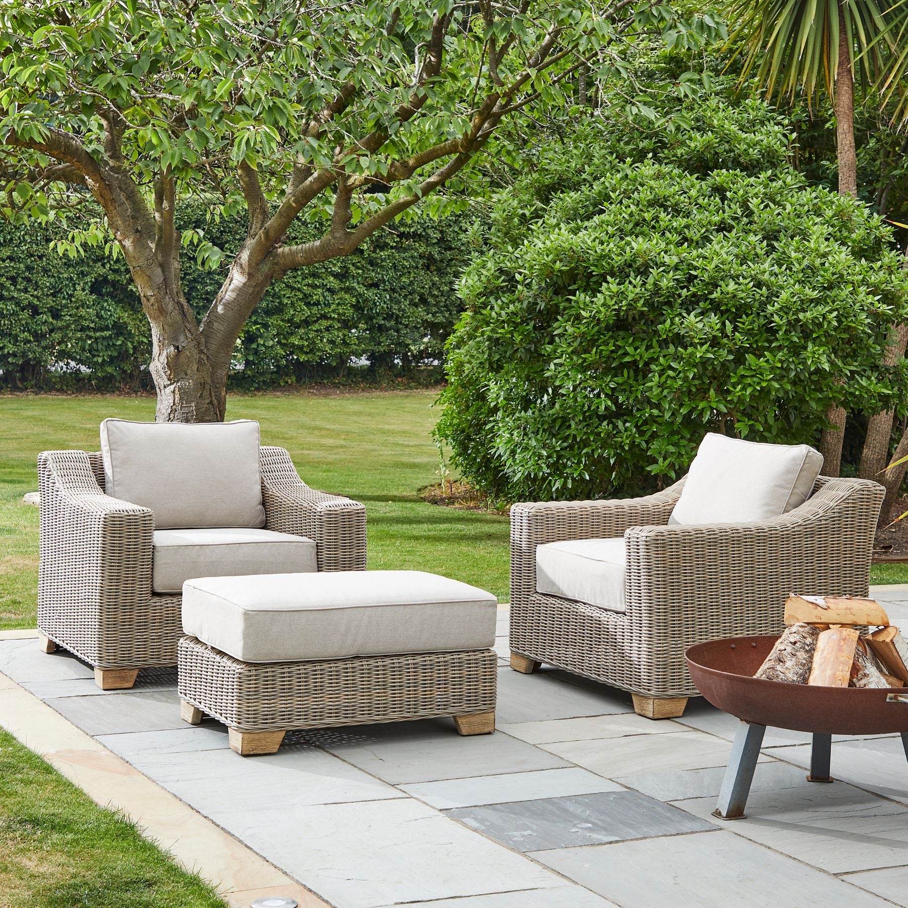 Capri Collection outdoor footstool styled in garden setting, weather-resistant rattan patio ottoman