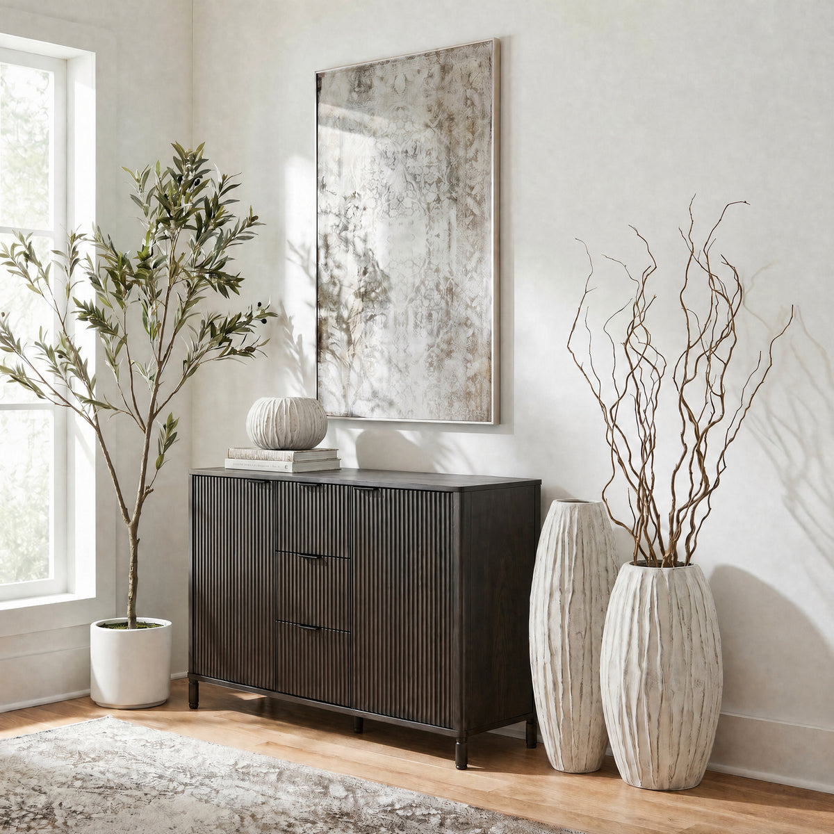 Lorenzo fin vase range styled with branches beside a dark sideboard in a neutral living room