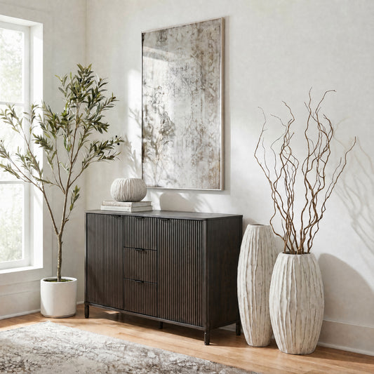 Lorenzo fin vase range styled with branches beside a dark sideboard in a neutral living room