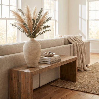 Morrow Medium Vase with tall foliage styled on a console behind a sofa