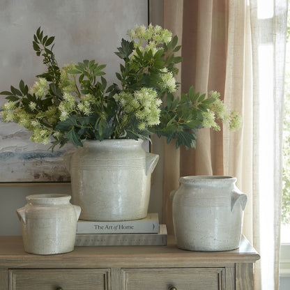 Tarn large handled pot at the centre of a three-pot display, styled with flowers beside a window
