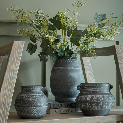 Etched Collection Vase at centre with foliage, displayed beside two smaller dark ceramic vessels