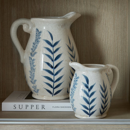 Large Blue Flora Olpe Jug Vase shown with the smaller coordinating blue botanical jug