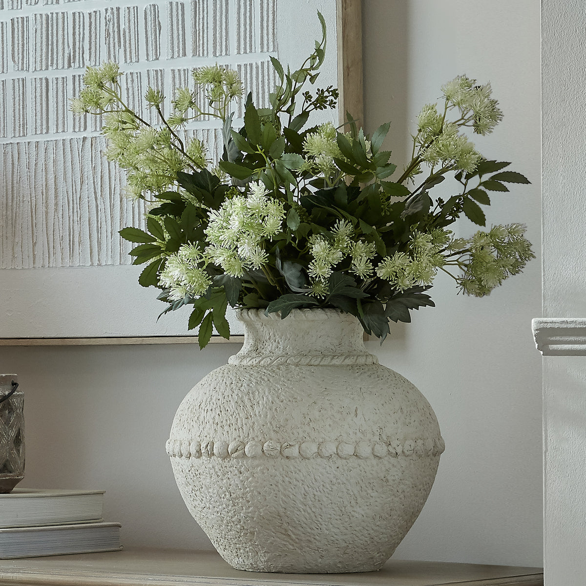 Medium Olympia Terracotta Vase with pale textured finish and foliage on a console