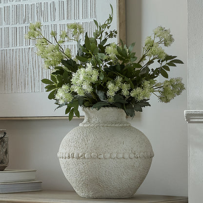 Medium Olympia Terracotta Vase with pale textured finish and foliage on a console
